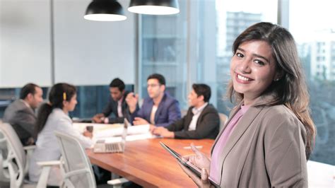 A beautiful office employee smiling at modern corporate office with colleagues Stock Footage,# ...