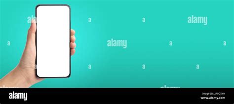 mockup hand touch on mobile blank screen on green background in banner size for display of ...