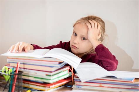 Premium Photo | Tired kid stressed pupil child doing homework ...