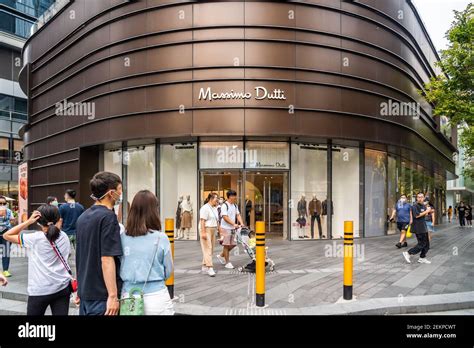 Pedestrians walk past a Massimo Dutti store in Shenzhen. (Photo by Alex ...