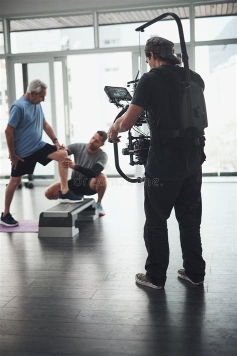 Getting Closer and Closer. Behind the Scenes Shot of a Camera Operator Shooting a Scene with a ...