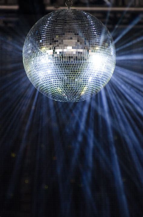 Disco balls create movement in light because they reflect the light in ...