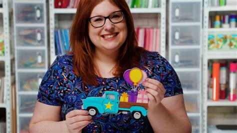 a woman holding a toy truck and balloon