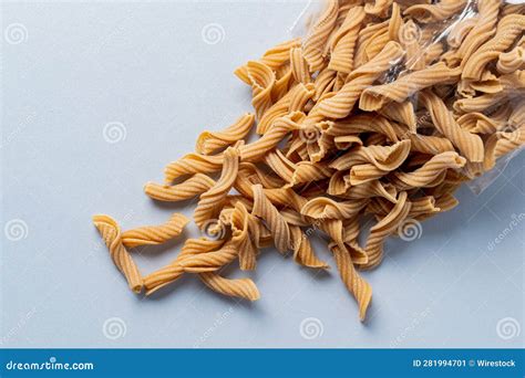 Variety of Cooked Pasta Pieces of Different Shapes and Sizes Arranged on a Light-colored Surface ...