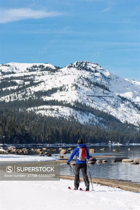 Woman skiing along shores of Donner Lake - SuperStock