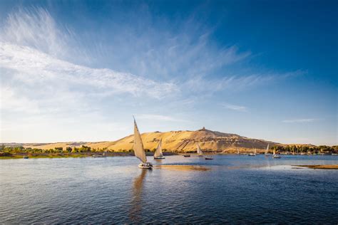 River Nile with traditional boats at sunset - Pure Vacations