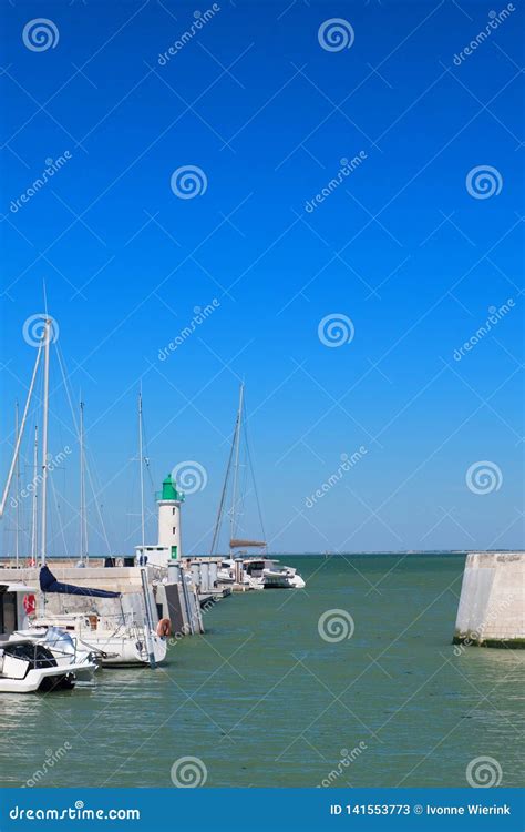 Ile De Re - Lighthouse and Boats in Harbor of La Flotte Stock Image ...