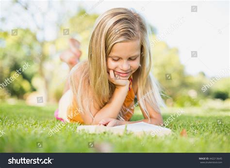 Young Girl Lying On Grass Reading Stock Photo (Edit Now) 442213645