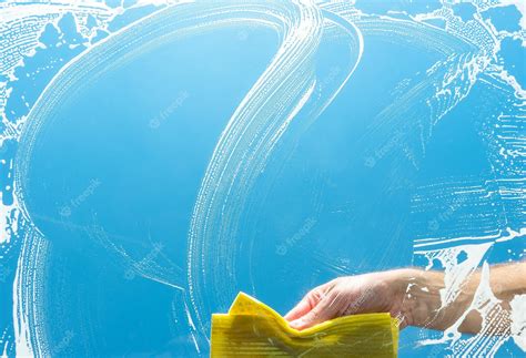 Premium Photo | Cleaning a glass window with yellow cloth