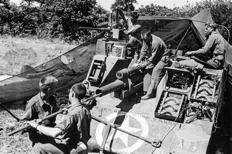 Crew of a 6th Armored Division swabs the tube of M7 late Summer 1944 | World War Photos