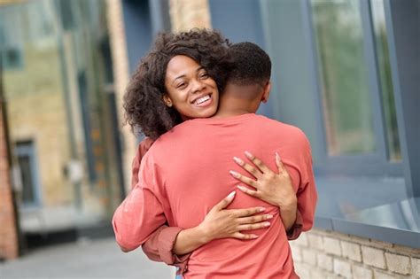 Premium Photo | Woman hugging man standing with back to camera