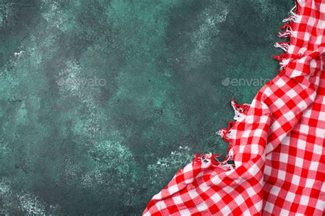 Red checkered tablecloth on green background Stock Photo by furmanphoto