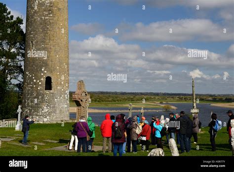 Tourists Stone round tower high cross crosses Clonmacnoise Monastery monastic settlement Offaly ...