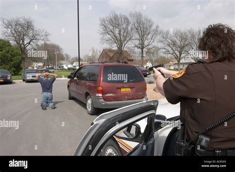 Felony traffic stop. Female deputy sheriff stopping motorist (training). Felony stops are high ...