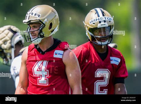 New Orleans Saints quarterbacks Derek Carr (4) and Jameis Winston (2) walk between drills during ...