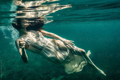 Underwater photo of Beautiful woman swimming in boho dress by Jenny ...