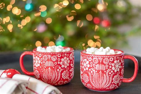 Closeup of Two Holiday Mugs of Hot Chocolate by the Christmas Tree ...