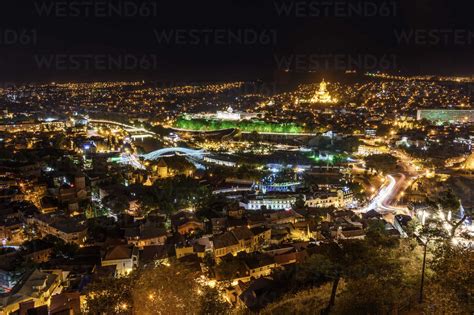 View across the city of Tbilisi, Georgia at night. stock photo