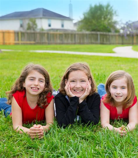 Children Girls Group Lying on Lawn Grass Smiling Happy Stock Photo - Image of group, funny: 31371594