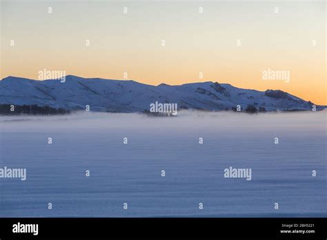 Snowy mountains at sunrise Stock Photo - Alamy