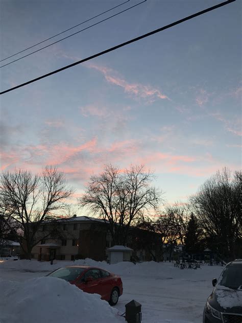 The 5pm sunset colors these altocumulus clouds pink as the sunlight bends through more of the ...