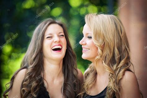 Two beautiful girls laughing together outdoors Stock Photo by ©pio3 ...