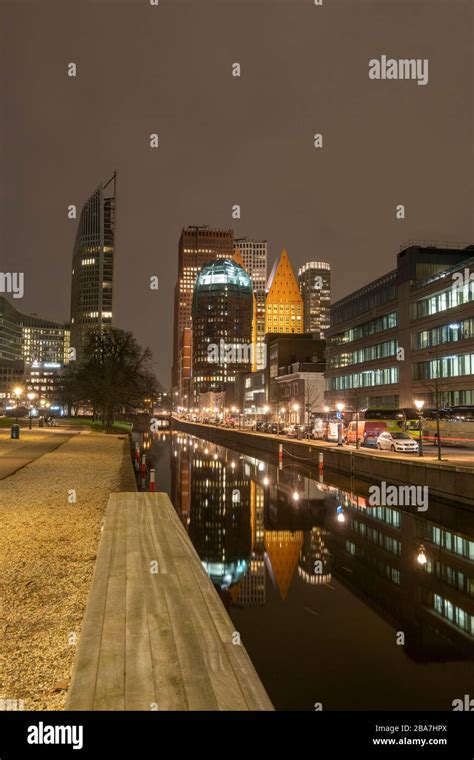 The Hague, the Netherlands - 18 February 2019: Skyline of The Hague at night with canal in front ...