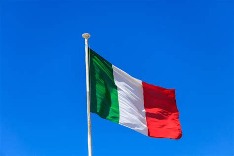 Italy flag. Italian flag on a pole waving on blue sky background - Bisphenol