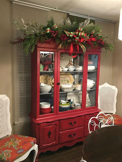 Greenery on red china cabinet ~~~~~~ I love that it has drawers that ...