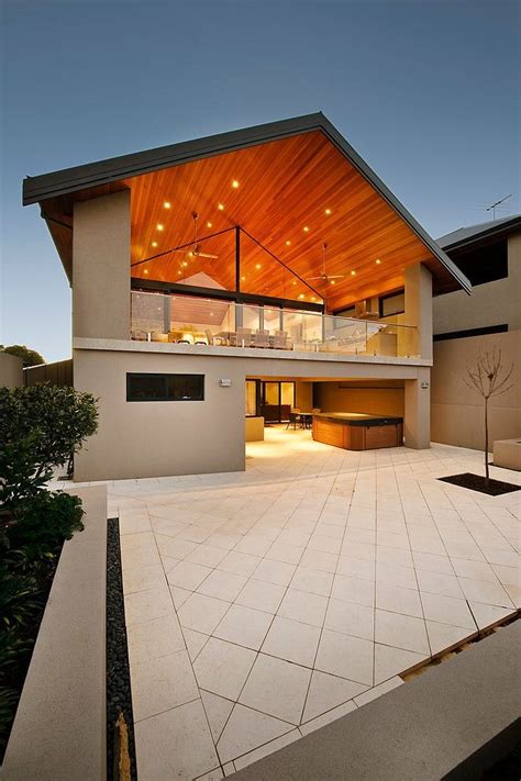 a modern house with an open floor plan and wood roofing on the top level