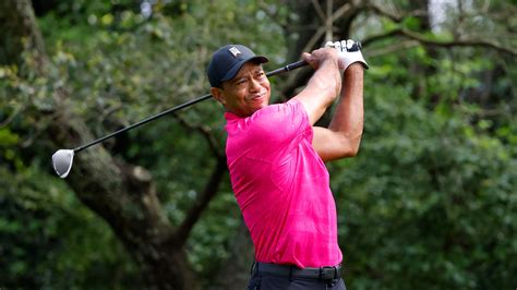Masters champion Tiger Woods plays a stroke from the No. 2 tee during practice round 1 for the ...