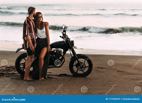 Couple On A Motorcycle On The Beach. A Couple In Love On The Beach ...