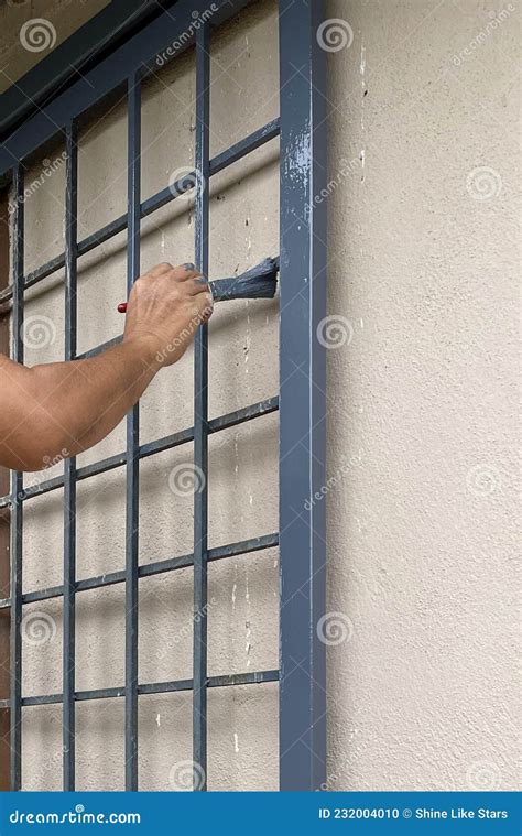 Painting iron gate stock photo. Image of person, house - 232004010