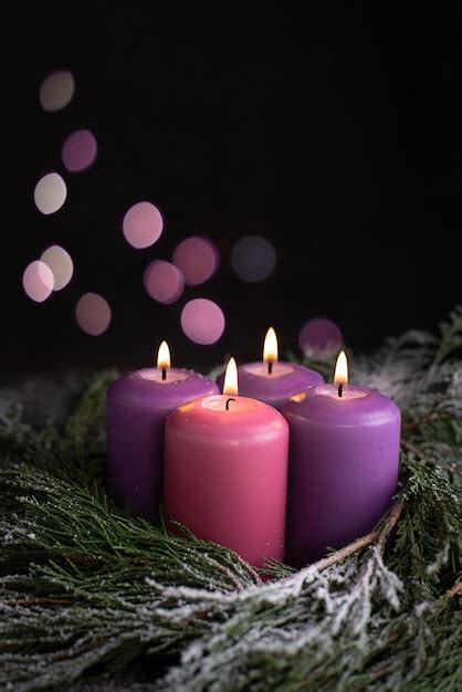 Premium Photo | Three christmas purple and one pink advent candle.