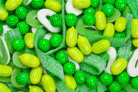 Premium Photo | Assorted green gummy candies background. top view. jelly sweets.