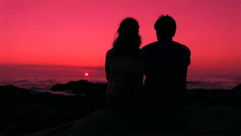 HD: Romantic Couple Sitting, Hug And Kiss At Sunset, Boy And Girl As A Silhouette Are Sitting At ...