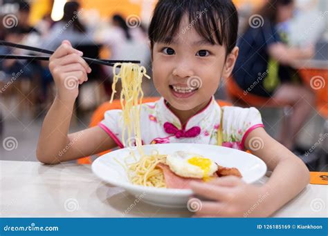 Asian Chinese Little Girl Eating Noodles with Chopsticks Stock Image - Image of happiness, cafe ...