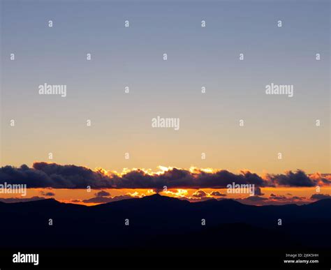 Mountain ridge at sunset with clouds Stock Photo - Alamy