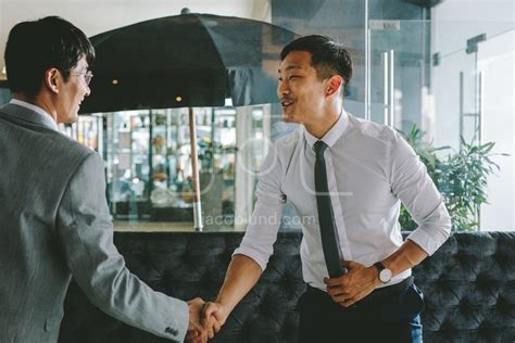 Business people greeting each other with a handshake – Jacob Lund Photography Store- premium ...