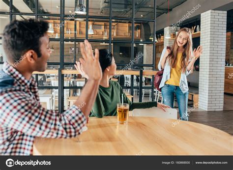 Multiethnic friends at cafe Stock Photo by ©NatashaFedorova 160868930