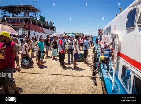 AUKI, SOLOMON ISLANDS - Dec 09, 2016: A crowd of people on Auki Wharf in Malaita Province of the ...