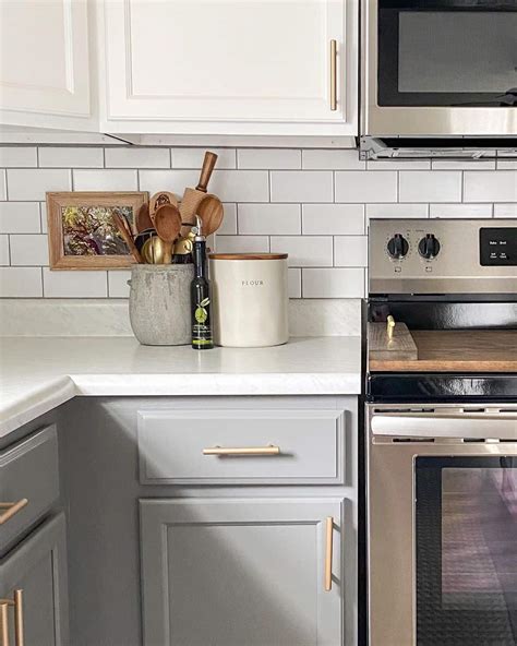 Stainless Steel Stove Pushed Against White Subway Tile Backsplash ...