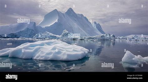 Giant iceberg the size of a mountain in Greenland surrounded by smaller ...