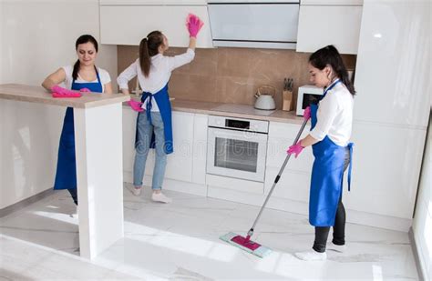 Professional House Cleaning. Three Beautiful Girls are Cleaning the Kitchen. Stock Image - Image ...
