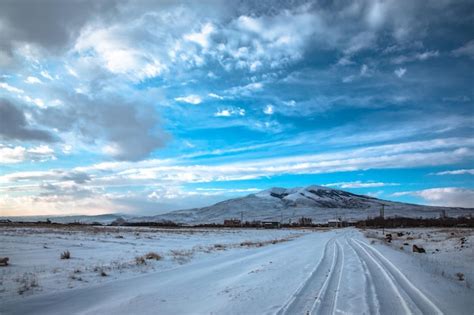 Premium Photo | Snowy road with mountain