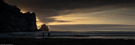 Two people silhouette in this Sunset at Morro Rock and Pil… | Flickr