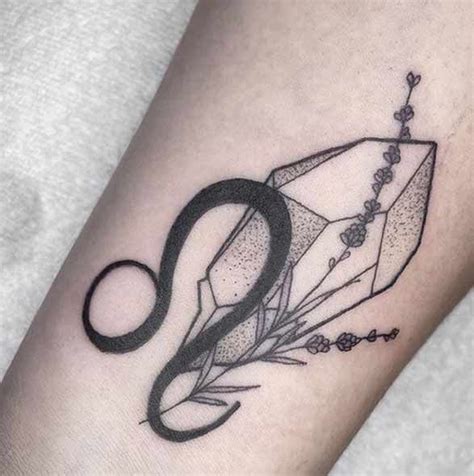 a black and white photo of a tattoo design on the arm that has an ...