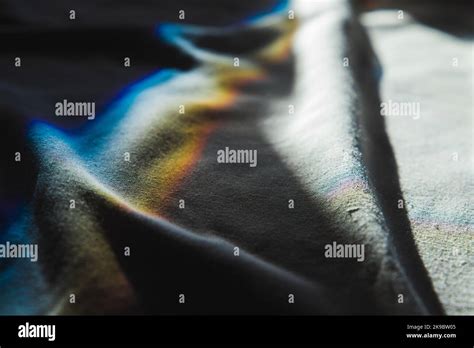 Sunbeams with soft spectrum colors go over white fabric, physical refraction effect. Abstract ...