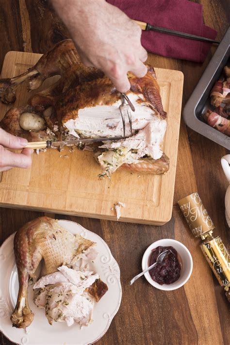 Man carving and serving Christmas roast turkey - Free Stock Image