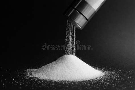 Pouring Salt from Shaker on Black Background, Closeup Stock Photo ...